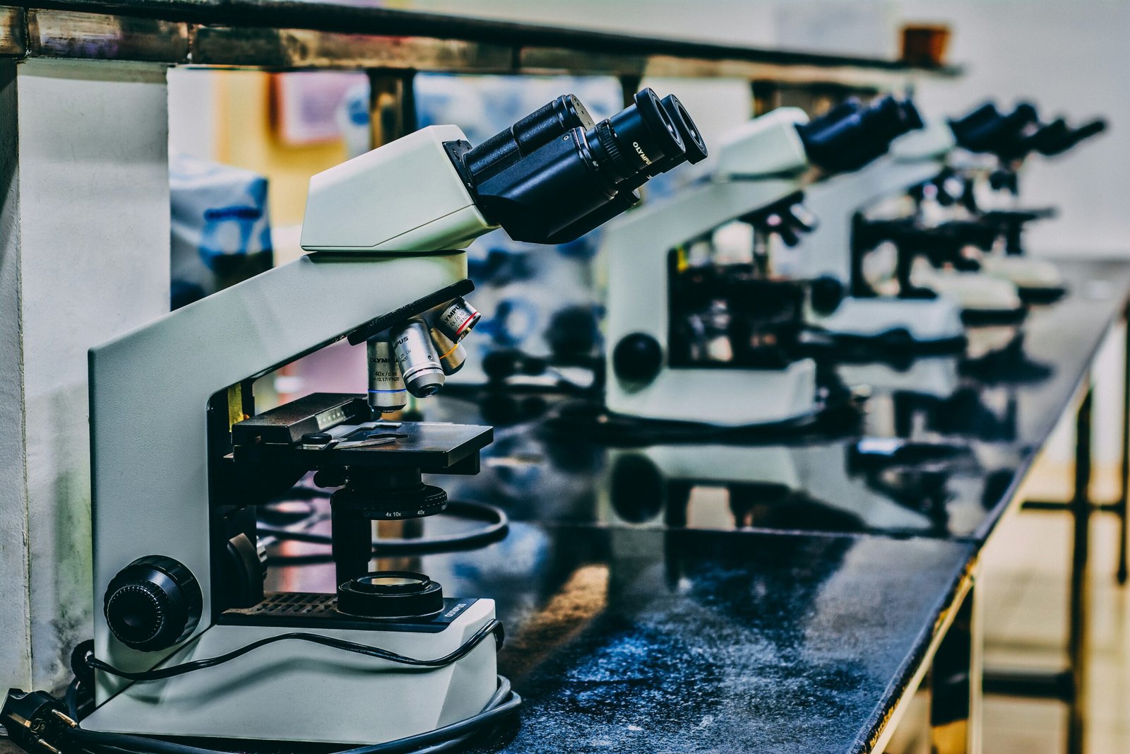 white microscope on top of black table